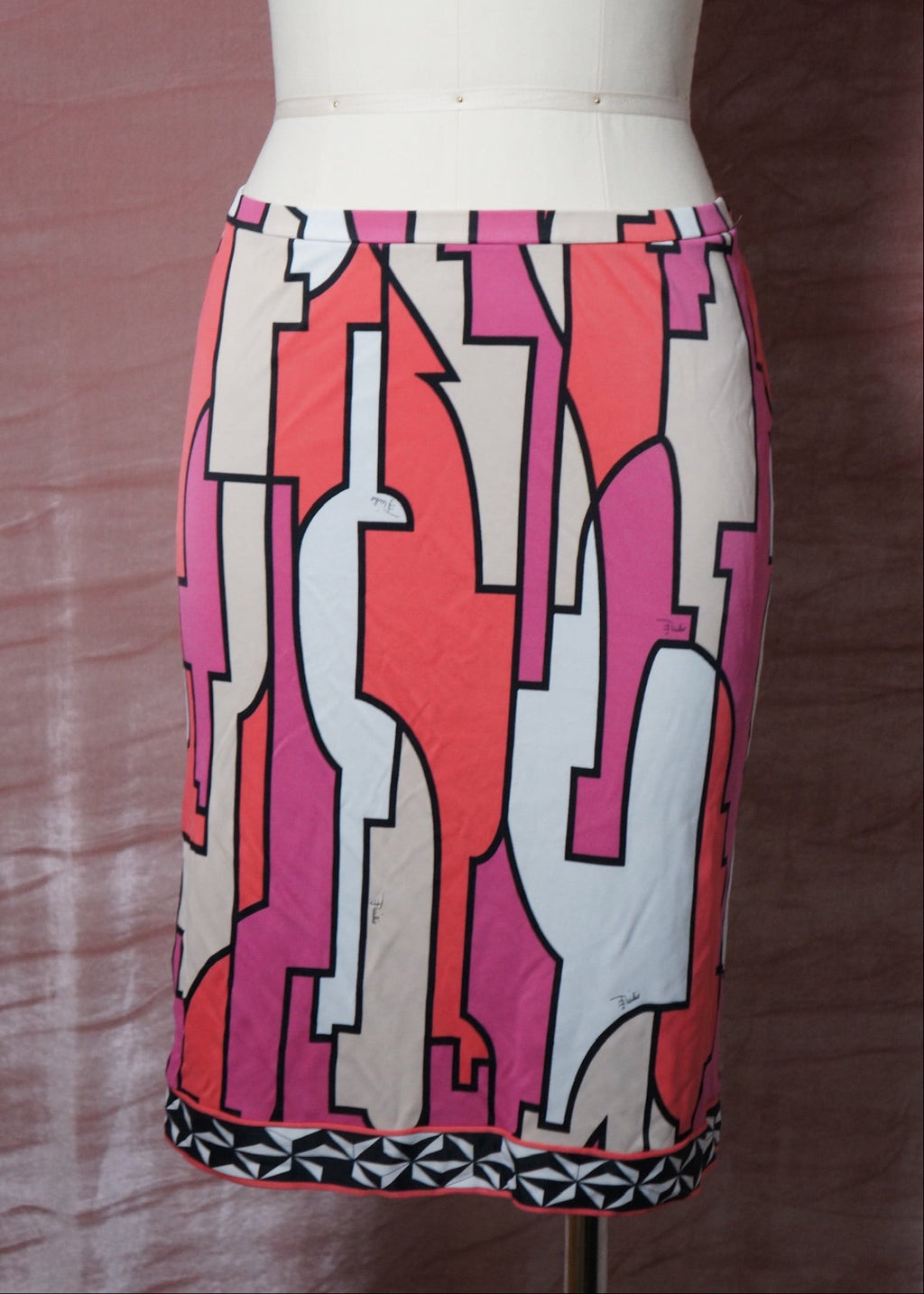 Colorful pucci geometric-patterned skirt on a mannequin against a brown background