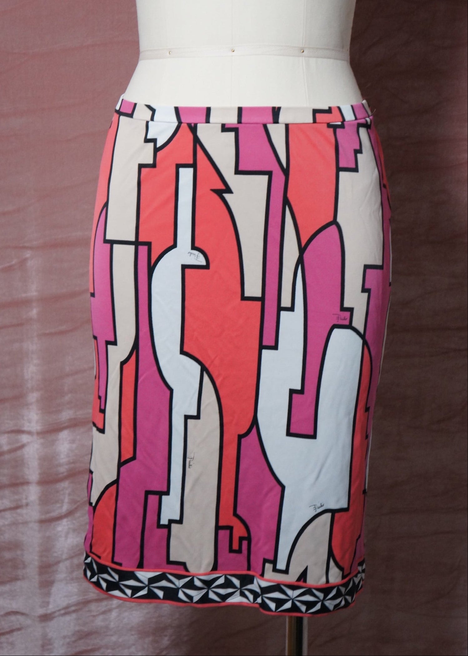 Colorful pucci geometric-patterned skirt on a mannequin against a brown background